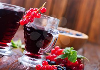 juice from berries in glasses and on a table