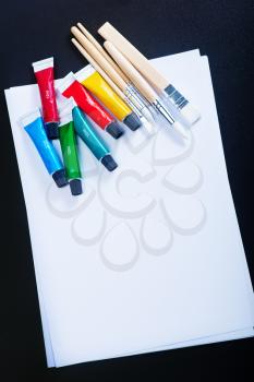 school supplies on the table, color paint and pencils