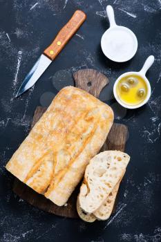 fresh bread with salt and olive oil on a table