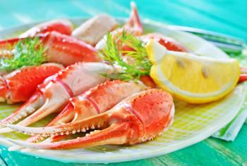 boiled crab claws with lemon on the plate