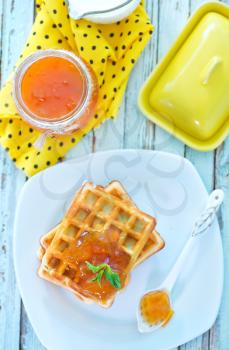 waffles with apricot jam on the plate