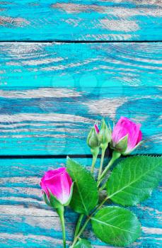 flowers on wooden background, red roses on a table