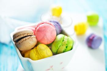 color macaroons in bowl and on a table