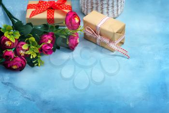 present and flowers on the blue background