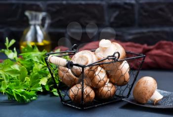 raw mushroom in metal basket and on a table