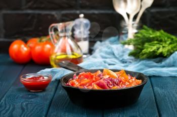 fried vegetables with tomato sauce in the pan