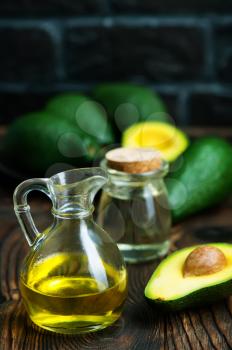 fresh avocado and oil in glass jug