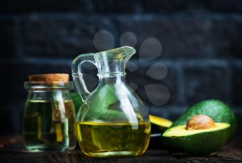 fresh avocado and oil in glass jug