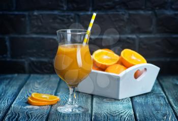 fresh orange juice in glass and on a table