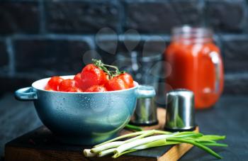 fresh tomato in bowl and on a table