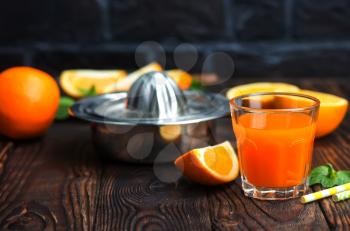 orange juice in glass and fresh fruits