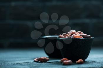 cocoa beans in bowl and on a table