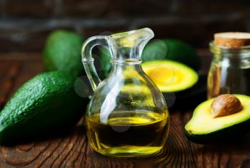 avocado oil in bottle and on a table