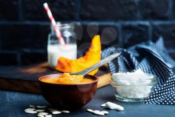 pumpkin porridge in bowl and on a table