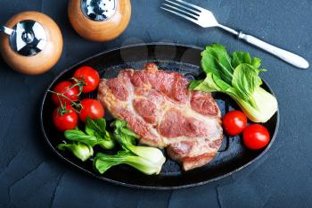 juicy fried steak on plate with salad
