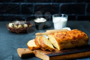 fresh bread on wooden board and on a table