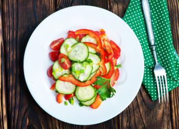fresh salad from vegetables on white plate