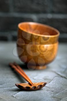 wood bowl with wooden chopsticks on a table