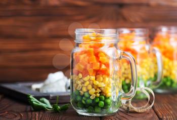 mix vegetables in glass bank and on a table
