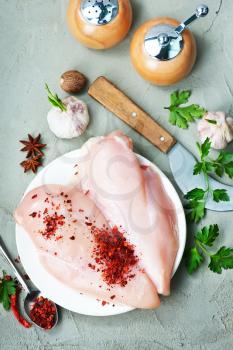 raw chicken fillet with spice on the board