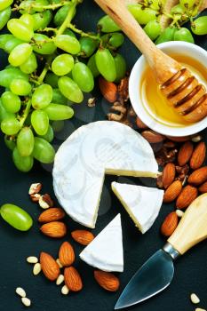 cheese with honey and nuts on a table