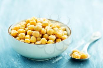 boiled chickpeas in bowl and on a table
