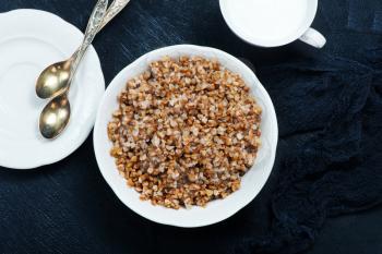 boiled buckwheat in bowl and on a table