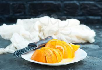 fresh orange on plate and on a table