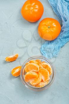 fresh tangerines in bowl and on a table