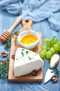 camembert with honey on board, stock photo