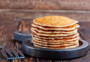 sweet pancakes on plate and on a table