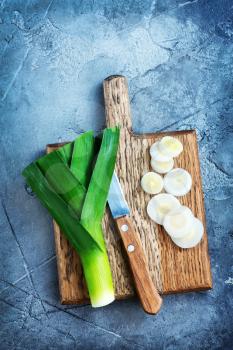 leek on wooden boards and on a table