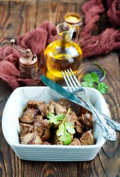 fried liver in bowl and on a table