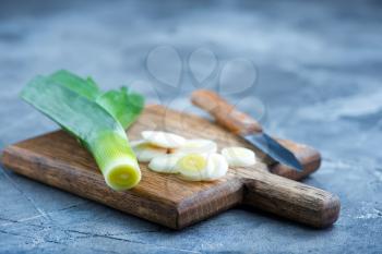 leek on wooden boards and on a table