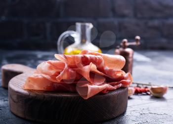 Prosciutto with spice on plate, stock photo