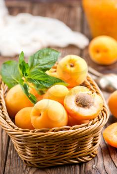fresh apricots in basket and on a table