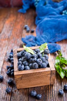 blueberry in wooden box and on a table