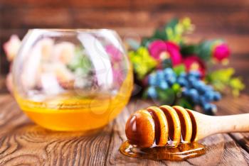 honey in glass bowl and on a table