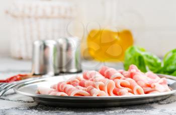 bacon with spice on the metal plate, stock photo