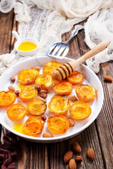 baked apricots with honey and nuts on a table