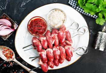 raw chicken hearts with salt and spice