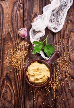 mustard in bowl and on a table
