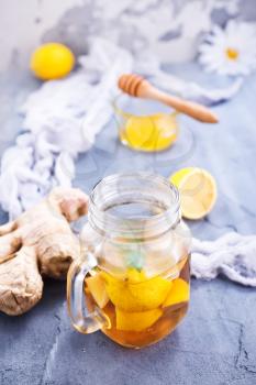 lemonad with fresh lemon and ginger on a table