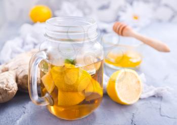 lemonad with fresh lemon and ginger on a table