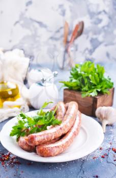 sausages with spice on white plate. stock photo