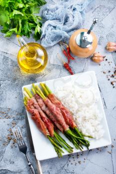 boiled rice with meat and green asparagus