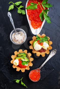 tartalets with butter and salmon caviar, fresh salmon with butter