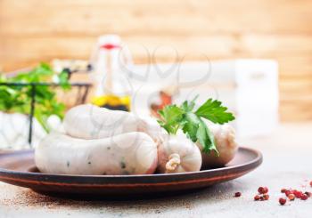 white sausages on plate and on a table
