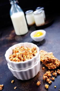 sweet granola with nuts and honey in the bowl