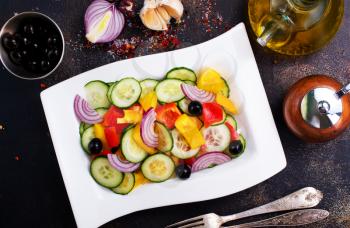 salad with olives and vegetables on white plate